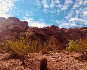 Rock formations on landscape against sky