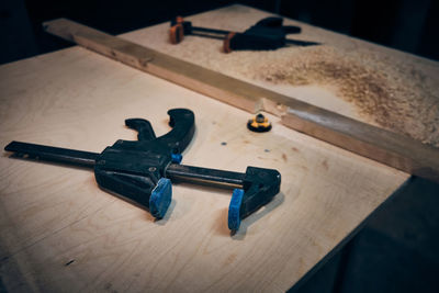 High angle view of hammer on wooden table