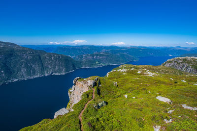 Scenic view of mountains against blue sky