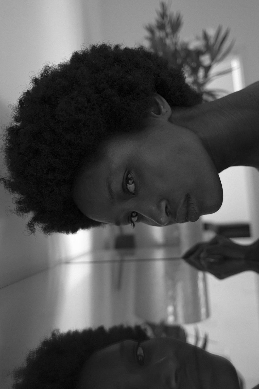 black, one person, black and white, portrait, white, curly hair, monochrome photography, monochrome, afro, indoors, headshot, women, human hair, adult, hairstyle, looking at camera, lifestyles, female, young adult, child, emotion, human face, close-up, childhood