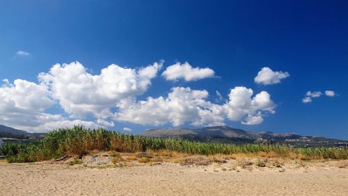 Scenic view of mountains against blue sky