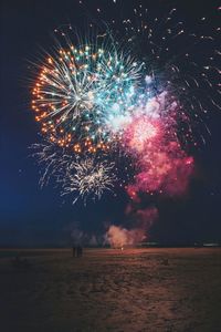 Low angle view of firework display at night