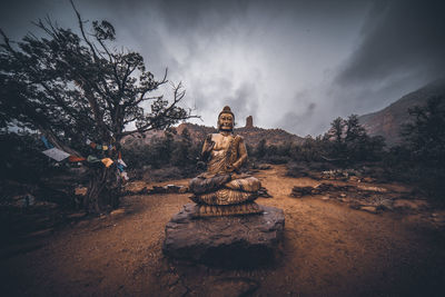 Golden buddha shrine during a winter snowfall in the arizona mountains