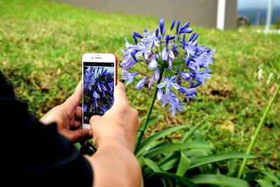 Midsection of person holding mobile phone