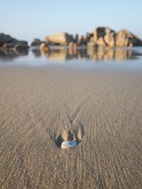 Surface level of sand on beach against sky