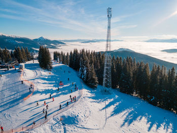 Snow covered landscape against sky