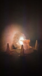 Close-up of burning candles on wooden table