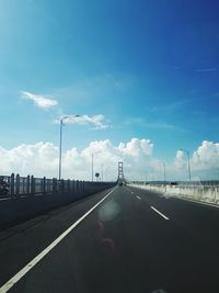 Vehicles on road against sky