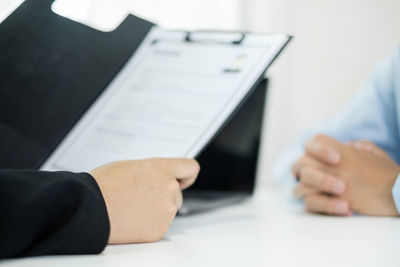 Cropped hands of man using laptop