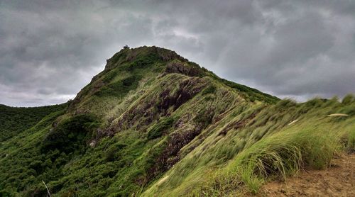 Scenic view of mountains against cloudy sky