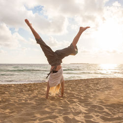 Rear view of woman walking on beach