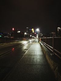 Illuminated road in city at night