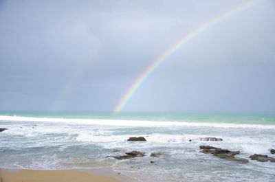 Scenic view of rainbow over sea