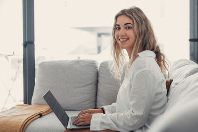 Young woman using laptop at home