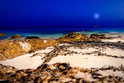 Scenic view of beach against blue sky