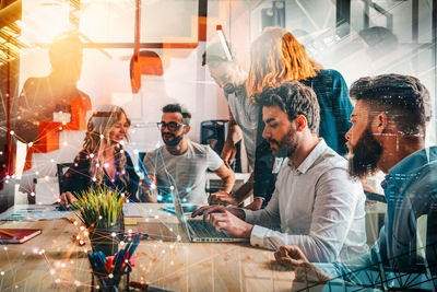 Portrait of smiling friends sitting at restaurant