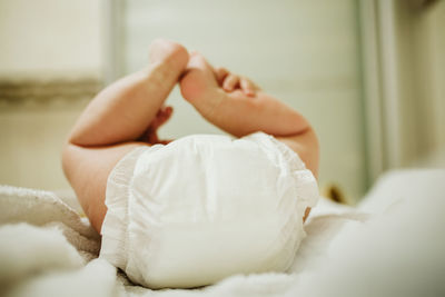 Low section of man lying on bed