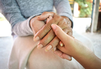 Close-up of couple holding hands