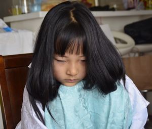 Close-up of girl sulking at home