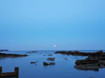 Scenic view of sea against clear blue sky