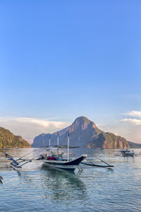 Sailboats in sea against sky