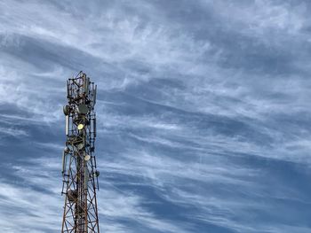 Low angle view of communications tower against sky