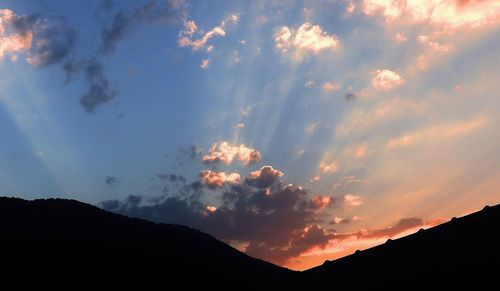 Scenic view of silhouette mountains against sky during sunset