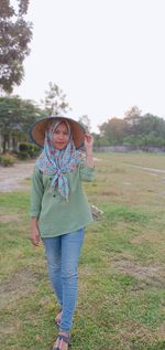 Portrait of smiling woman standing on field