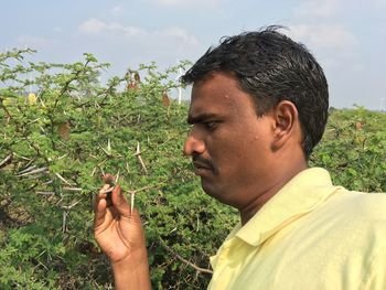 Close-up of senior woman against plants