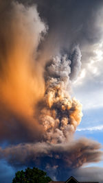 Smoke emitting from volcanic mountain against sky 