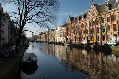 Boats in canal with buildings in background