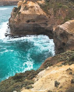 Rock formation in sea against sky