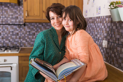 Portrait of young woman reading book