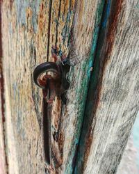 Close-up of rusty metal on wood