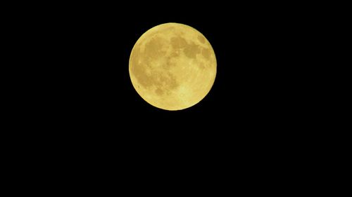 Low angle view of moon against clear sky at night