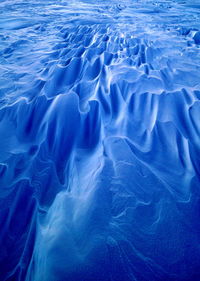 Aerial view of sea with mountain in background