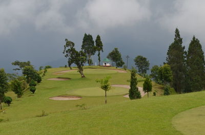 Scenic view of golf course against sky