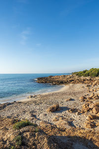 Scenic view of beach against blue sky