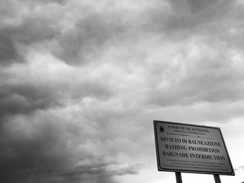 Low angle view of road sign against sky