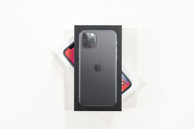 High angle view of camera phone on white background