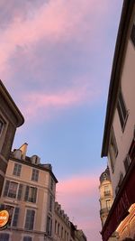 Low angle view of buildings in town against sky