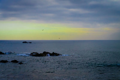 Scenic view of sea against sky at sunset