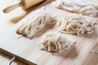 High angle view of noodles on cutting board