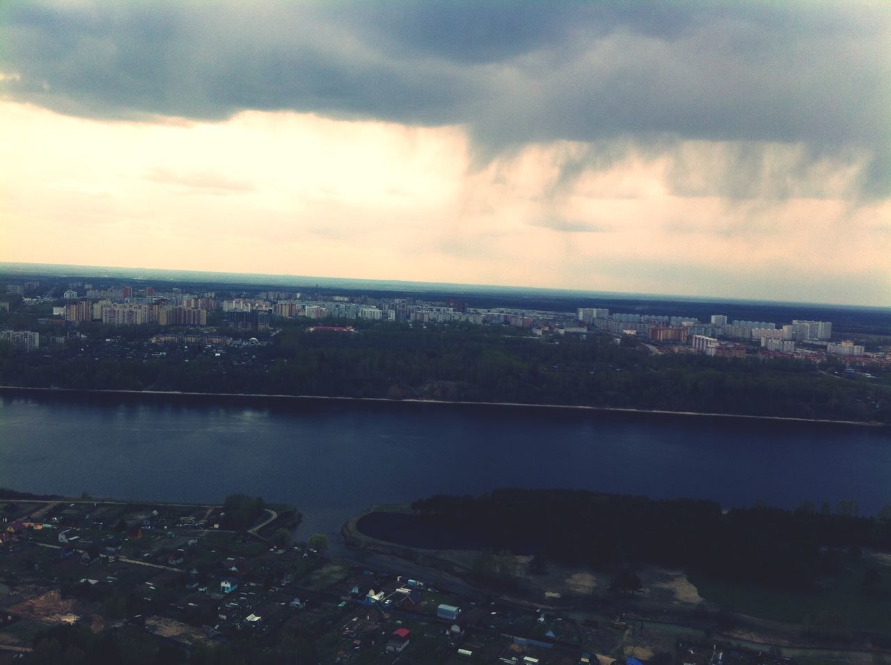 cityscape, architecture, city, sky, built structure, building exterior, water, cloud - sky, river, crowded, high angle view, residential district, cloudy, cloud, residential building, aerial view, residential structure, outdoors, city life, sea