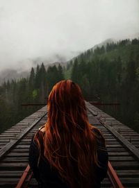 Back view of a woman facing alpine landscape