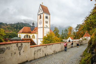 Traditional building by trees against sky