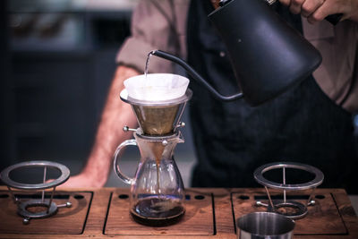 Midsection of man preparing coffee