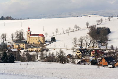 People skiing on snow covered landscape