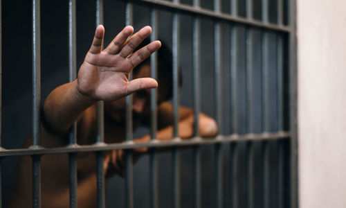 Prisoner showing hand while standing in prison