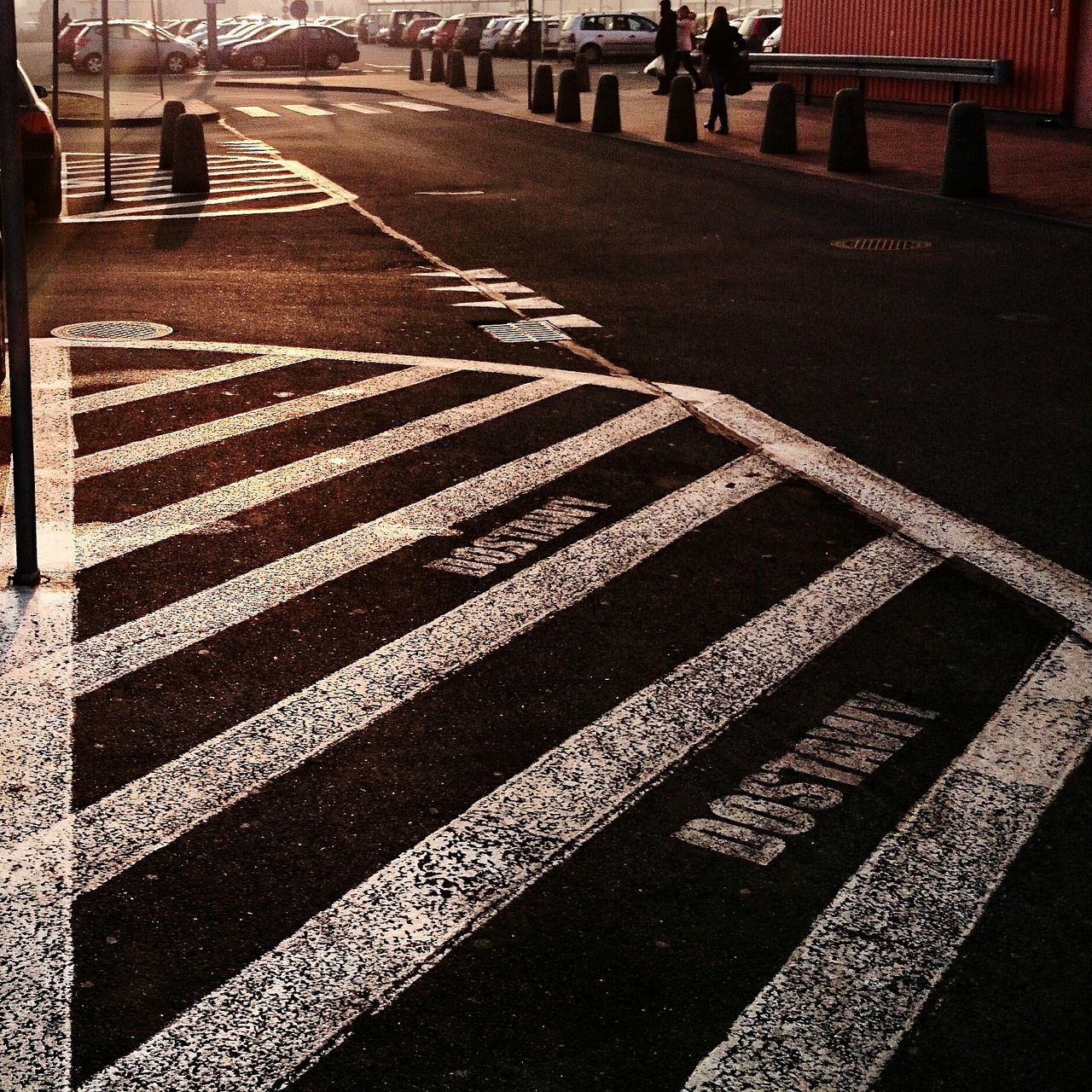 road marking, street, road, transportation, the way forward, zebra crossing, asphalt, shadow, walking, incidental people, city, high angle view, sunlight, diminishing perspective, unrecognizable person, outdoors, vanishing point, day, in a row